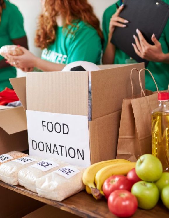 diverse volunteers collecting food and clothes donations in warehouse diverse volunteers collecting food and clothes donations in warehouse